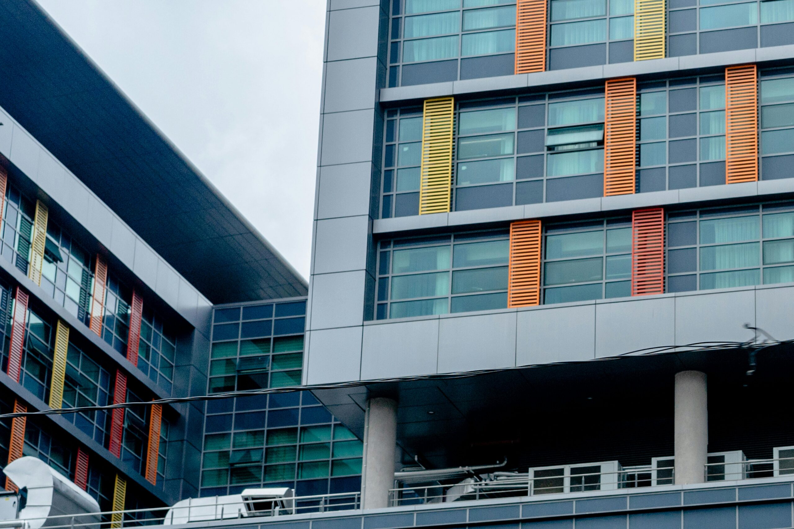Modern building with colorful facade and glass windows showcasing urban architecture.